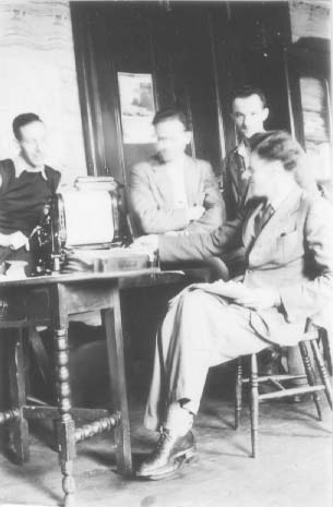 Inside the headquarters. George Noseda (left) with the duplicator. Harold Atkinson seated (right)